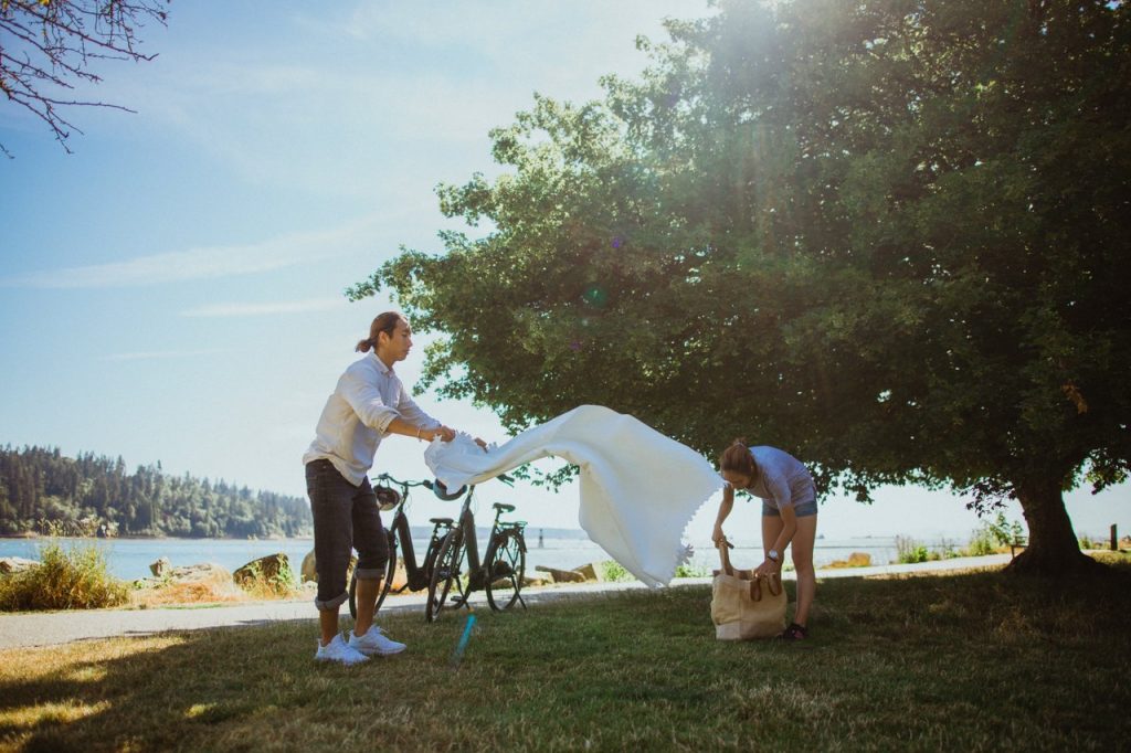 couple having picnic on blanket