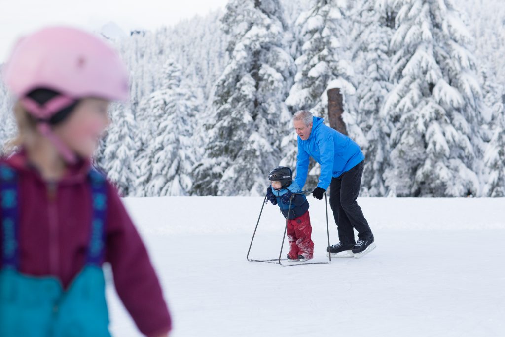 Man and child ice skating on Grouse Mountain