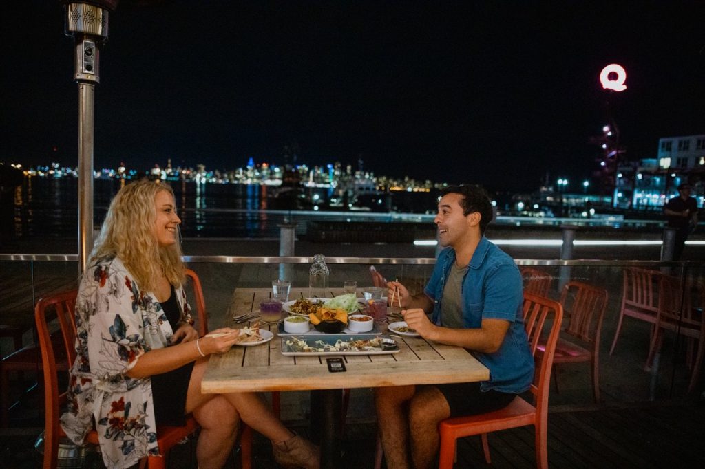 Couple eating dinner on patio at night