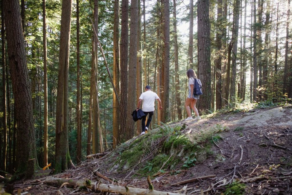 Couple running through forest