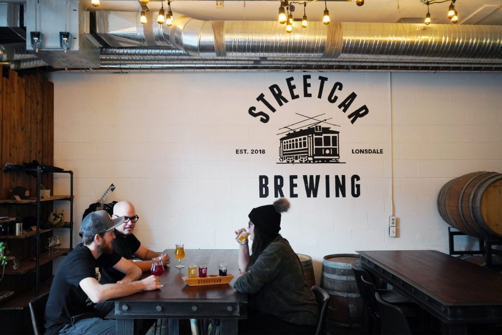 Group of friends drinking craft beer at Streetcar Brewing