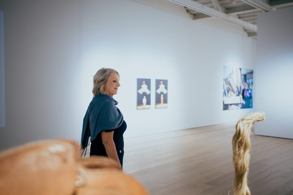 Woman walking around art gallery
